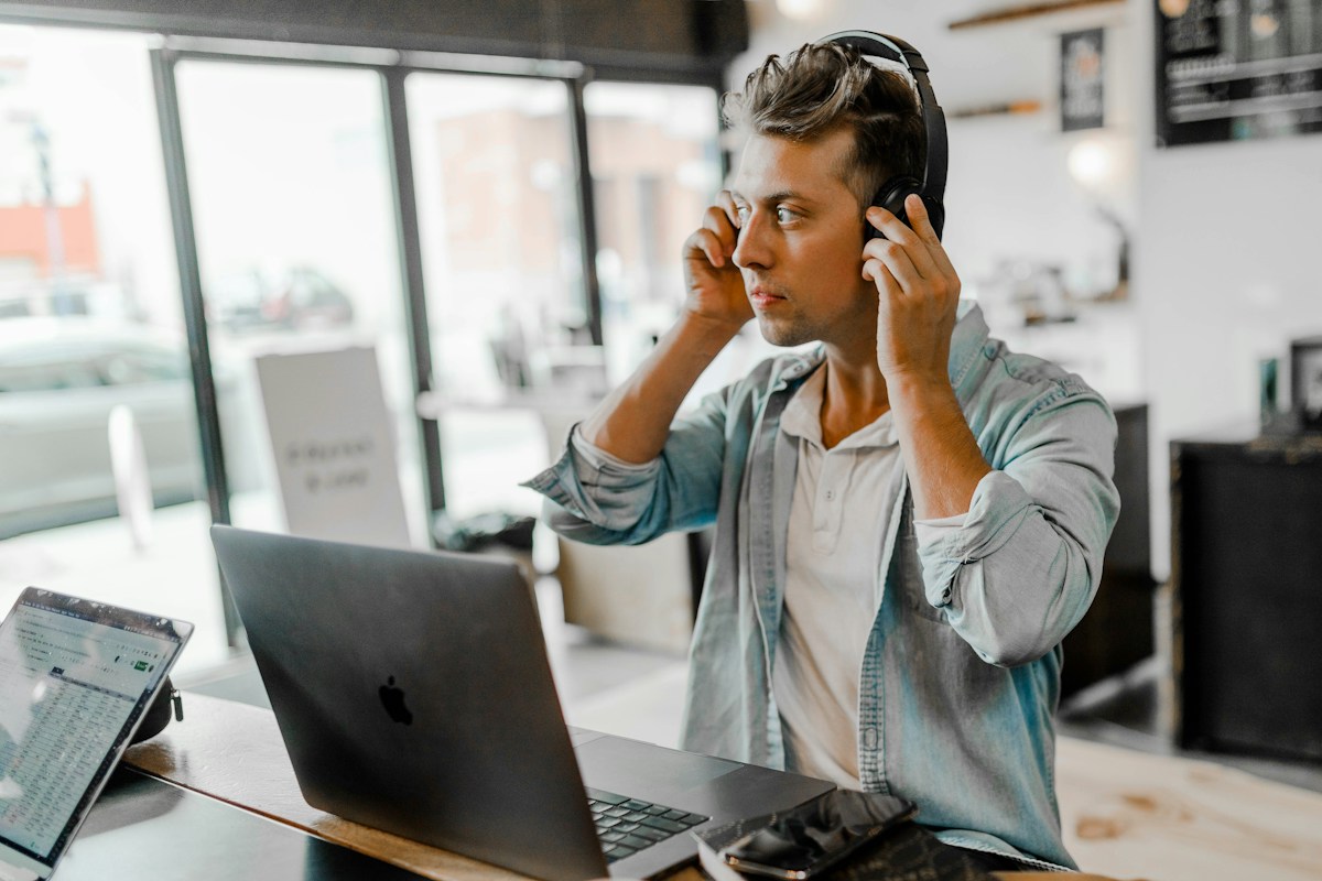 Support specialist with a headset working on a laptop